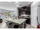 Open kitchen featuring granite countertops, stainless steel appliances, dark cabinets, and adjacent dining area at 7769 Peaceful Trellis Dr, Las Vegas, NV 89179