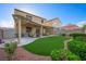 Large backyard with a covered patio, outdoor furniture, artificial grass, and mature landscaping at 7916 Nesting Pine Pl, Las Vegas, NV 89143