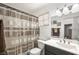 Bathroom featuring a shower curtain, toilet, and vanity at 7916 Nesting Pine Pl, Las Vegas, NV 89143