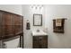 Bathroom features dark wood cabinet, toilet, sink, and modern fixtures at 7916 Nesting Pine Pl, Las Vegas, NV 89143