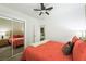 A bright bedroom with a full mirror and floral wallpaper at 7916 Nesting Pine Pl, Las Vegas, NV 89143