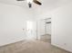 Bright bedroom featuring neutral carpet, large closet, ceiling fan, and access to additional rooms at 7916 Nesting Pine Pl, Las Vegas, NV 89143