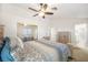 Bedroom with a ceiling fan and a bed with patterned bedding at 7916 Nesting Pine Pl, Las Vegas, NV 89143