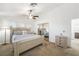 Bright bedroom featuring a ceiling fan, and a large bed with blue accents at 7916 Nesting Pine Pl, Las Vegas, NV 89143