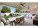 Spacious outdoor dining area with comfortable seating and a well-manicured backyard at 7916 Nesting Pine Pl, Las Vegas, NV 89143