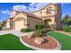 Two-story stucco home with a red tile roof, well-manicured lawn, and a two-car garage at 7916 Nesting Pine Pl, Las Vegas, NV 89143