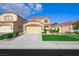 Two-story home with red tile roof, two car garage and well maintained lawn at 7916 Nesting Pine Pl, Las Vegas, NV 89143