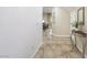 Spacious tiled entry way with table and plant, leading to dining area at 7916 Nesting Pine Pl, Las Vegas, NV 89143
