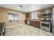 Kitchen with stainless steel appliances, tile floors, wood cabinets and lots of natural light at 7916 Nesting Pine Pl, Las Vegas, NV 89143