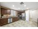 Bright kitchen features stainless steel appliances, wood cabinets, tile flooring, and lots of storage at 7916 Nesting Pine Pl, Las Vegas, NV 89143