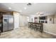 Open-concept kitchen features stainless steel appliances, bar seating, and tile flooring at 7916 Nesting Pine Pl, Las Vegas, NV 89143