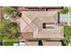 Bird's-eye view of a home featuring a unique roof design, an outdoor patio, and well-manicured landscaping at 8316 Imperial Lakes St, Las Vegas, NV 89131