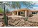 Backyard with desert landscaping featuring drought-tolerant plants and a covered patio at 8316 Imperial Lakes St, Las Vegas, NV 89131