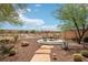 The backyard features a desert landscaped yard with a fire pit and scenic views at 8316 Imperial Lakes St, Las Vegas, NV 89131