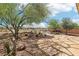 Desert landscape backyard with a stone walkway leading to a fire pit and seating area at 8316 Imperial Lakes St, Las Vegas, NV 89131