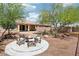Relaxing backyard featuring desert landscaping, a seating area with a fire pit, and a private fence at 8316 Imperial Lakes St, Las Vegas, NV 89131