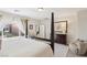 Well-lit bedroom featuring a four-poster bed, dresser, and comfortable seating at 8316 Imperial Lakes St, Las Vegas, NV 89131