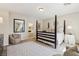 Cozy bedroom with a four-poster bed, neutral decor, and a glimpse of the bathroom at 8316 Imperial Lakes St, Las Vegas, NV 89131