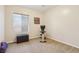 Bright bedroom featuring neutral carpet, a window, and home exercise equipment at 8316 Imperial Lakes St, Las Vegas, NV 89131