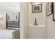 Stylish bedroom entryway featuring decorative niche and glimpse of a modern four-poster bed at 8316 Imperial Lakes St, Las Vegas, NV 89131