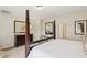 Comfortable bedroom setup with a four-poster bed, dresser, and neutral decor at 8316 Imperial Lakes St, Las Vegas, NV 89131