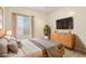 Bedroom featuring a well-lit window, modern furniture, a cozy bed, and a serene atmosphere at 8316 Imperial Lakes St, Las Vegas, NV 89131