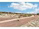 Scenic community trail winding through natural desert landscape, perfect for walking, running, and biking at 8316 Imperial Lakes St, Las Vegas, NV 89131