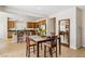 Dining area adjacent to kitchen with stainless appliances and breakfast bar at 8316 Imperial Lakes St, Las Vegas, NV 89131