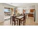 Bright dining area with modern table, chairs, and kitchen view leading to outdoor patio at 8316 Imperial Lakes St, Las Vegas, NV 89131