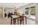Dining area with glass table, chairs, and sliding doors to outside patio at 8316 Imperial Lakes St, Las Vegas, NV 89131