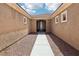 Home entrance with a long walkway leading to the front door and desert landscaping at 8316 Imperial Lakes St, Las Vegas, NV 89131