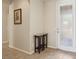 Inviting entryway with neutral walls, tiled floor, and decorative accent table leading to interior space at 8316 Imperial Lakes St, Las Vegas, NV 89131