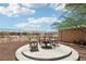 Backyard fire pit area with comfortable seating, ideal for enjoying evenings outdoors at 8316 Imperial Lakes St, Las Vegas, NV 89131