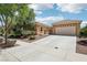 Charming home with a two-car garage, desert landscaping, and a concrete driveway leading to the entrance at 8316 Imperial Lakes St, Las Vegas, NV 89131