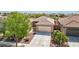 Charming single-story home with a well-manicured lawn, desert landscaping, and a spacious three-car garage at 8316 Imperial Lakes St, Las Vegas, NV 89131