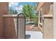 A charming front yard is visible through an iron gate, with a sidewalk leading to the house at 8316 Imperial Lakes St, Las Vegas, NV 89131