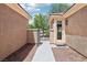 View of a home's entry, featuring desert landscaping and a secure, gated courtyard at 8316 Imperial Lakes St, Las Vegas, NV 89131