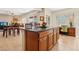 Open-concept kitchen island with breakfast bar and a view of the dining and living areas at 8316 Imperial Lakes St, Las Vegas, NV 89131