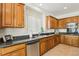 Kitchen with stainless steel appliances, granite counters, and wood cabinets at 8316 Imperial Lakes St, Las Vegas, NV 89131