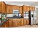 Charming kitchen features stainless steel appliances and wooden cabinets and dark granite countertops at 8316 Imperial Lakes St, Las Vegas, NV 89131