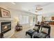 Inviting living room with a fireplace, comfortable lounge chairs, and seamless access to the kitchen at 8316 Imperial Lakes St, Las Vegas, NV 89131