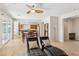 Bright living room with tile flooring, ceiling fan, and sliding glass doors leads to kitchen and dining area at 8316 Imperial Lakes St, Las Vegas, NV 89131