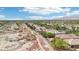 Expansive view of a neighborhood, set against mountains, complemented by walking paths and lush greenery at 8316 Imperial Lakes St, Las Vegas, NV 89131