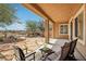 Inviting covered patio with stone flooring, perfect for outdoor relaxation and enjoying the desert landscape at 8316 Imperial Lakes St, Las Vegas, NV 89131