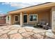 Covered patio featuring a stone floor and comfortable seating, ideal for outdoor relaxation at 8316 Imperial Lakes St, Las Vegas, NV 89131