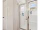 Modern walk-in shower featuring glass doors, neutral color tones, and tiled walls with built-in shelving at 8316 Imperial Lakes St, Las Vegas, NV 89131