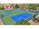 Aerial view of blue tennis and pickleball courts surrounded by green fencing and desert landscaping at 8316 Imperial Lakes St, Las Vegas, NV 89131