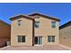 A tan two-story home with a private brick patio and neutral stucco exterior at 8324 S Miller Ln, Las Vegas, NV 89113
