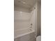 Clean white tile bathtub and shower with a curved shower curtain rod in a well-lit bathroom at 8324 S Miller Ln, Las Vegas, NV 89113