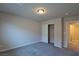 Neutral bedroom featuring an open closet and a glimpse of the hallway through a door at 8324 S Miller Ln, Las Vegas, NV 89113